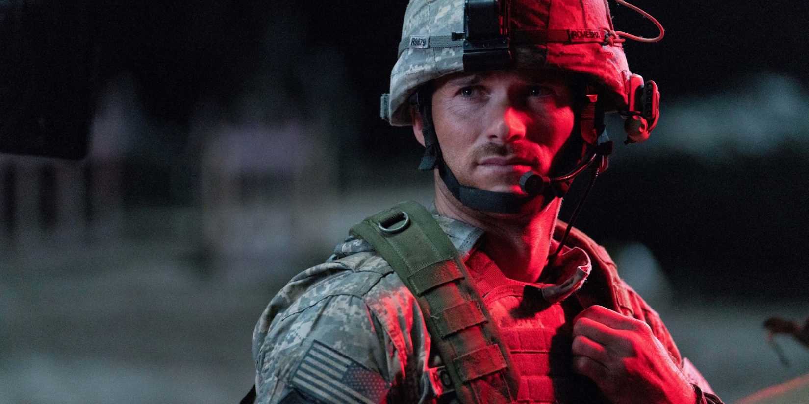 Staff Sergeant Clint Romesha (Scott Eastwood) in a military helmet at night in The Outpost