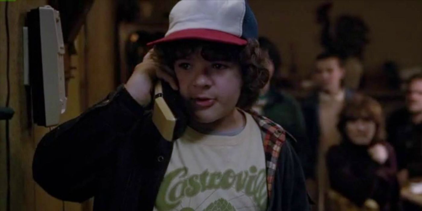 Stranger Things' Dustin on the phone while everyone behind him watches