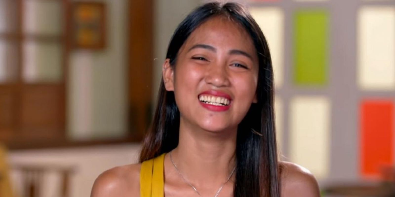 rosemary vega 90 day fiance smiling in yellow top