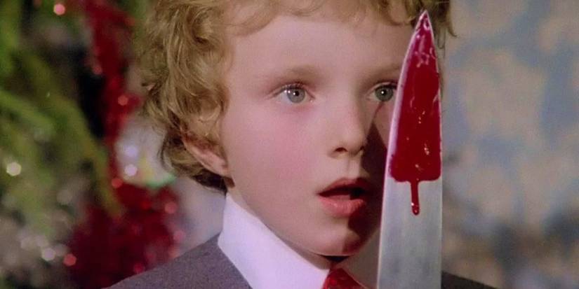 Young Carlo (Jacopo Mariani) looking shocked at a bloody knife in front of his face in Deep Red.