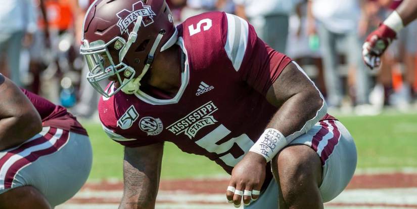 Chauncey Rivers bending down on the football field