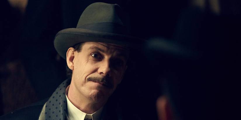 Darby Sabini tilts his head and grimaces in in Peaky Blinders.