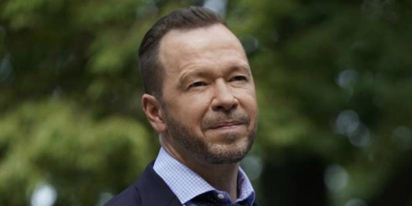 Danny in Blue Bloods with a small smile