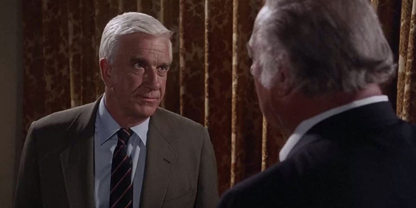 Leslie Nielsen as Frank Drebin staring at another man in The Naked Gun