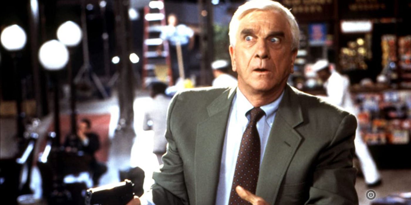 Leslie Nielsen as Frank Drebin looking scared and shocked in The Naked Gun 2 1/2.