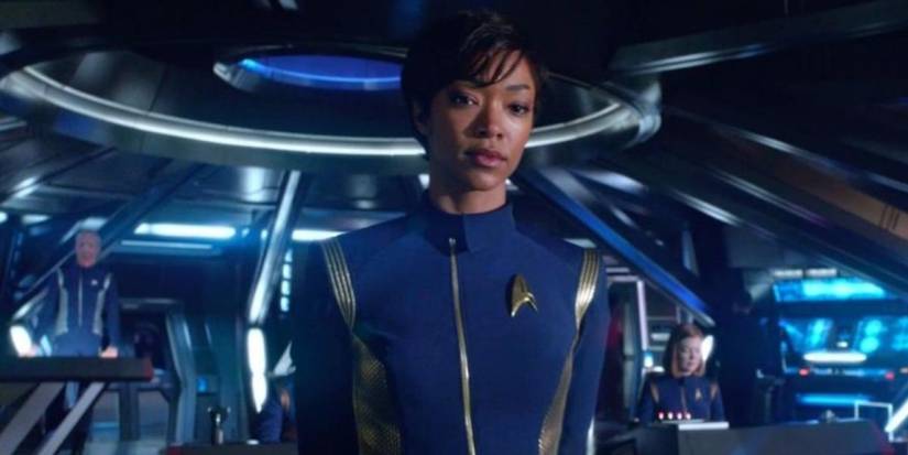 Commander Michael Burnham stands looking thoughtful on the bridge of the USS Shenzhou in Star Trek: Discovery season 1.