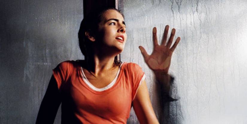 Jill pressing her hand against a window in When A Stranger Calls