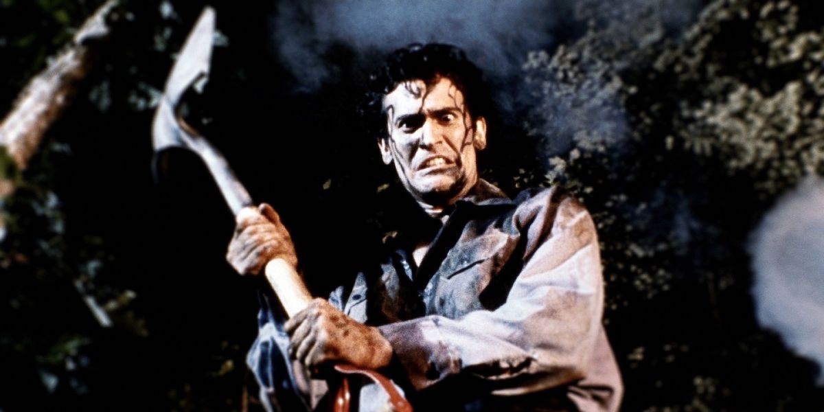 Ash standing outside with a shovel looking down at the camera in Evil Dead II