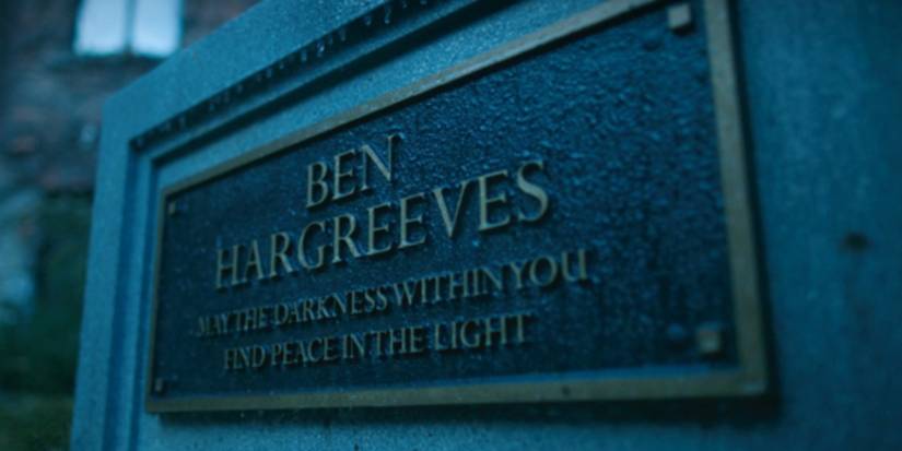 Ben Hargreeves' gravestone with his name and the inscription "May the darkness within you find peace in the light”