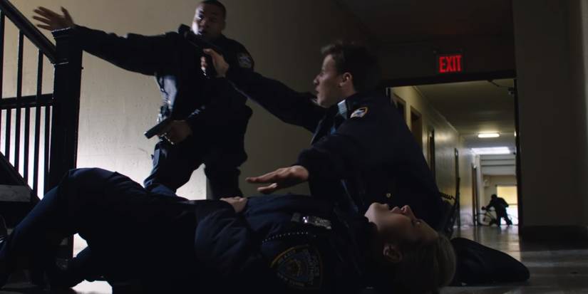 Jamie with a fallen Eddie talking to another officer in Blue Bloods