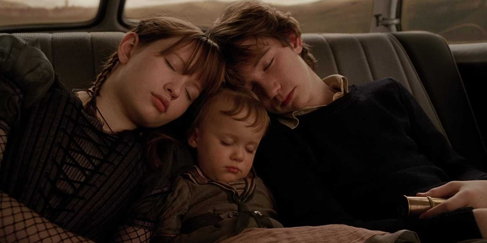 A screenshot of the Baudelaire children sleeping at back of Mr. Poe's car from Lemony Snicket's A Series of Unfortunate Events