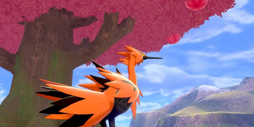 pokemon's galarian zapdos is next to the legendary tree.