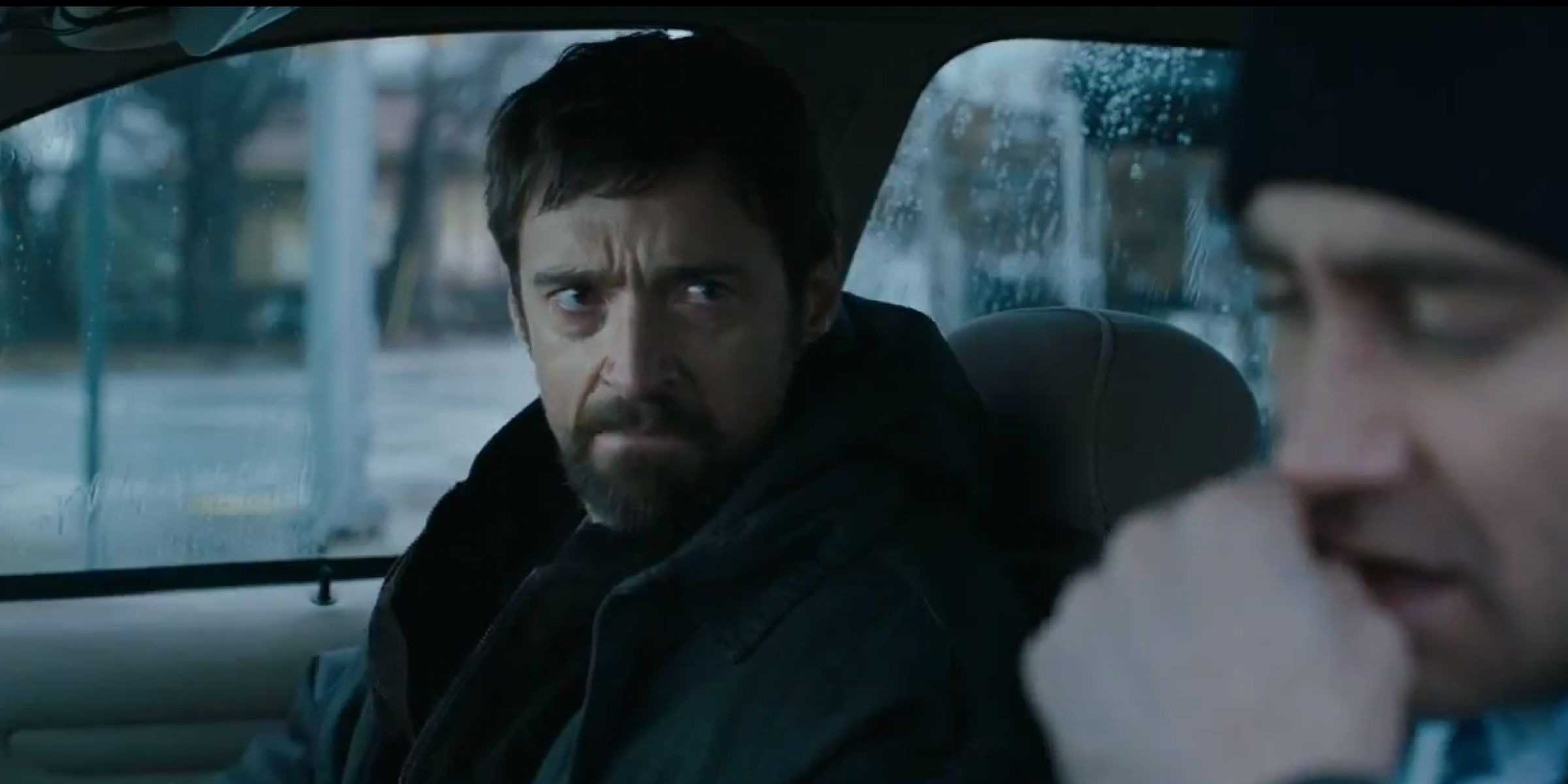 Hugh Jackman and Jake Gyllenhaal sitting in a car in Prisoners.