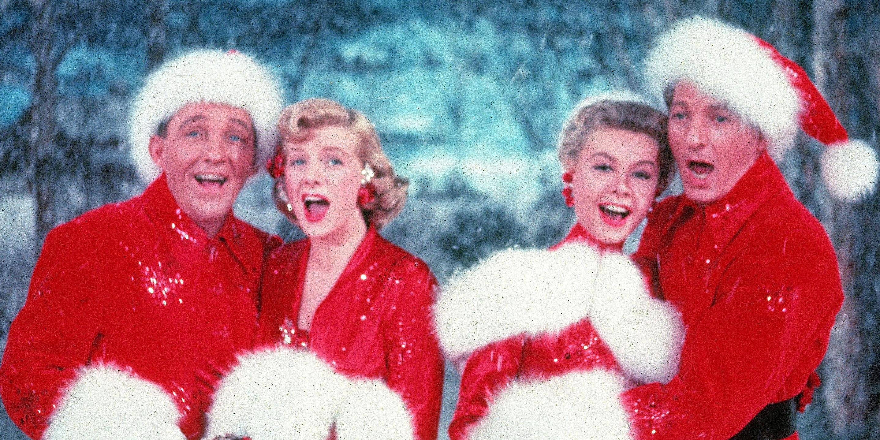 Bing Crosby as Bob Wallace, Rosemary Clooney as Betty Haynes, Danny Kaye as Phil Davis, and Vera-Ellen as Judy Haynes dressed in Santa costumes in White Christmas