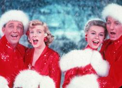 Bing Crosby as Bob Wallace, Rosemary Clooney as Betty Haynes, Danny Kaye as Phil Davis, and Vera-Ellen as Judy Haynes dressed in Santa costumes in White Christmas