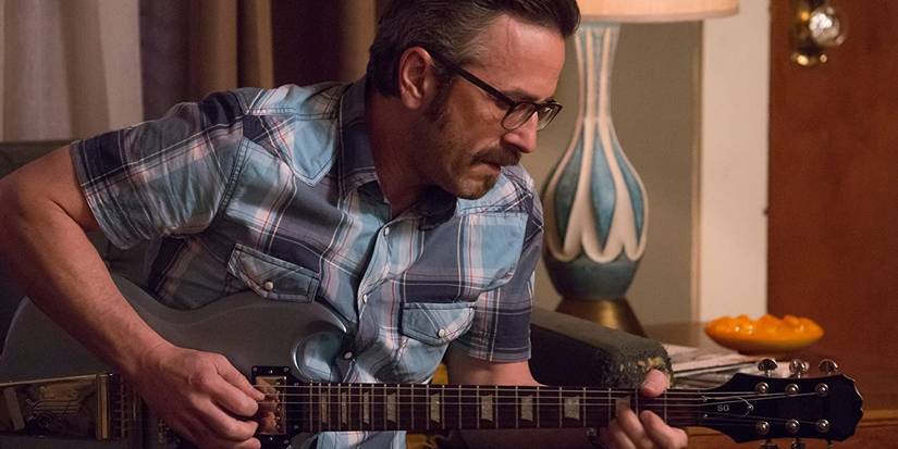 Marc Maron playing the guitar 