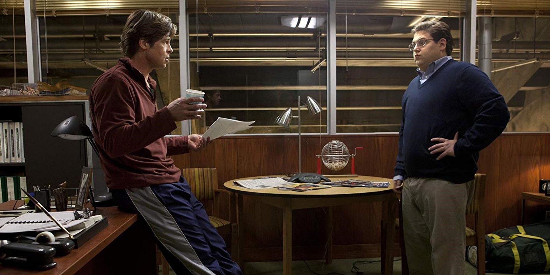 Billy Beane and Peter Brand talking in an office in Moneyball 