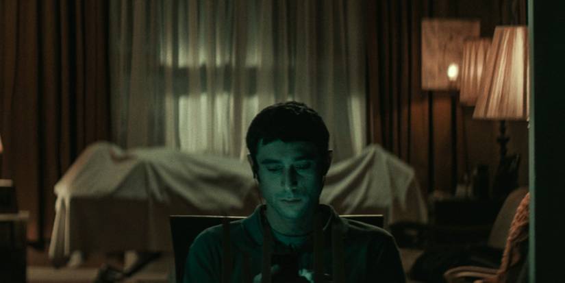 A man sits in the darkness from the Vigil