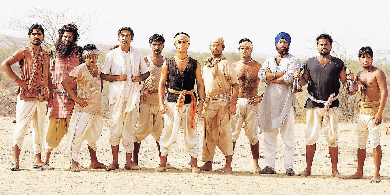 The team in Lagaan standing side by side outside and looking at the camera