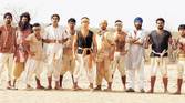 The team in Lagaan standing side by side outside and looking at the camera