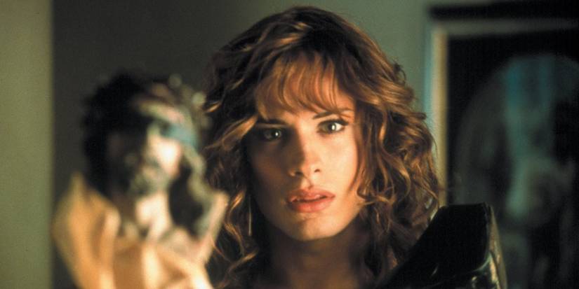 Gael García Bernal as Zahara looks at herself in the mirror with a statue of Jesus in the foreground from Bad Education