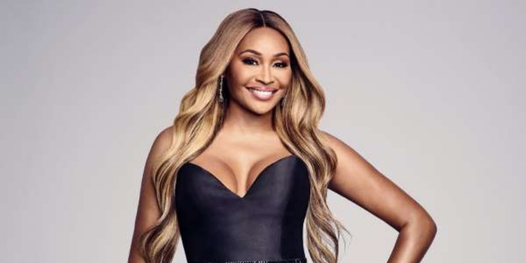 Cynthia Bailey from RHOA smiling with a black top on