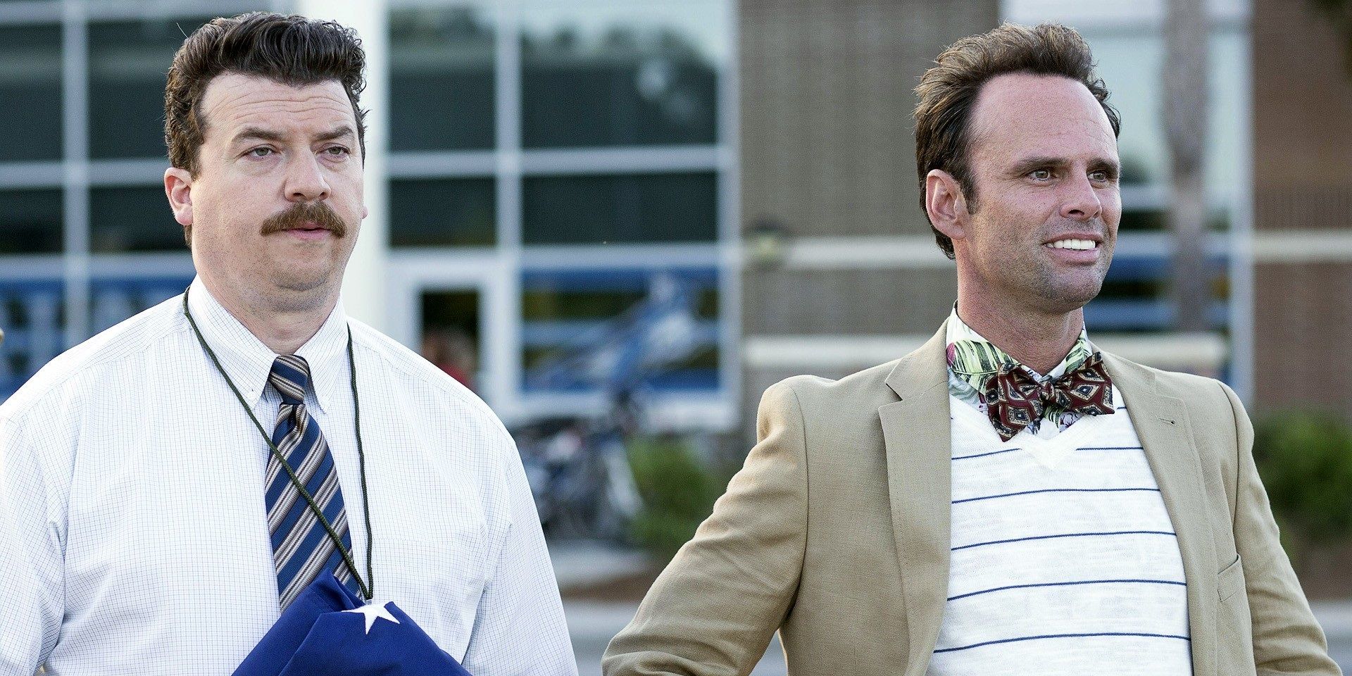 Neal and Lee stand together outside the school in Vice Principals