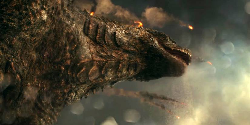 Godzilla vs Kong - A shot from beneath Godzilla with debris flying in the sky above