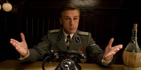 Hans Landa speaks with the Basterds in a dark room in Inglourious Basterds