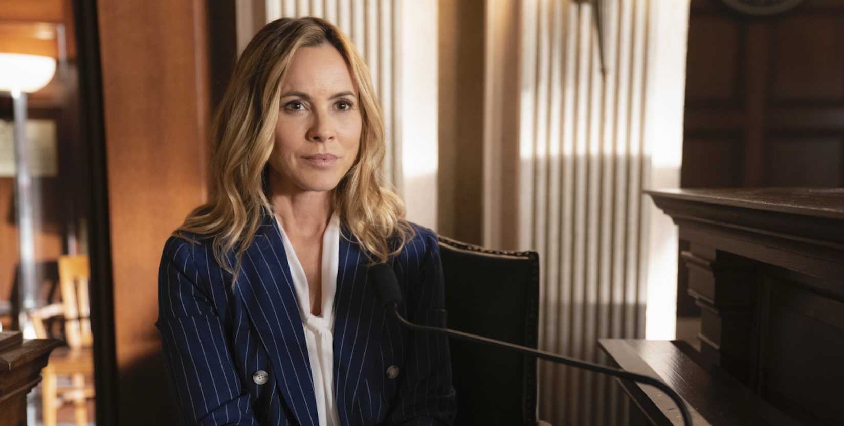 Jack Sloane (Maria Bello) sitting and smiling in NCIS.