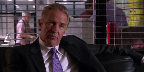 Thomas Matthews sits on the couch in Dexter