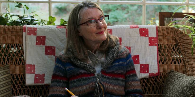 Hope smiling while sitting on her sofa