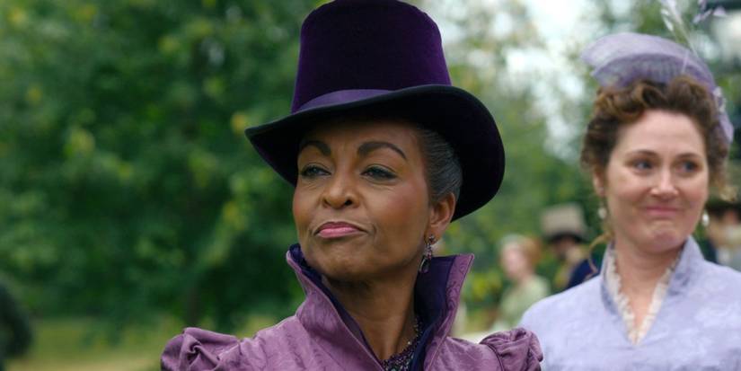 Lady Danbury smiles with Violet in the background in Birdgerton.