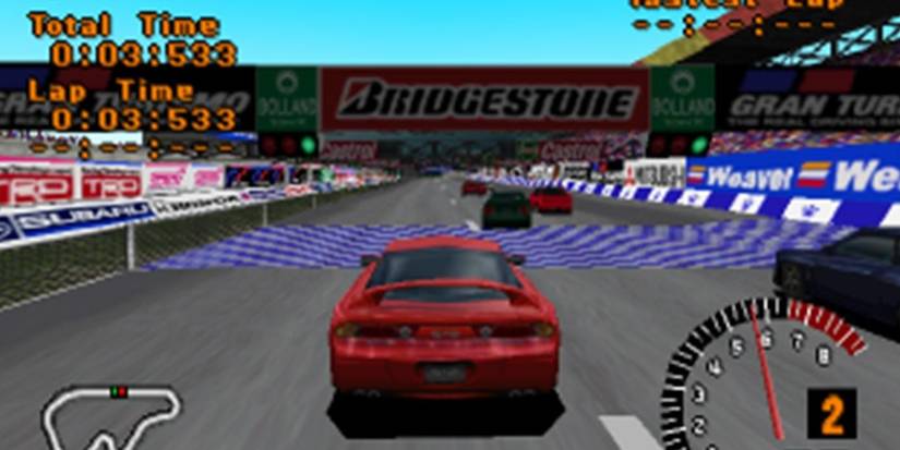 A red car races around a speedway from Gran Turismo