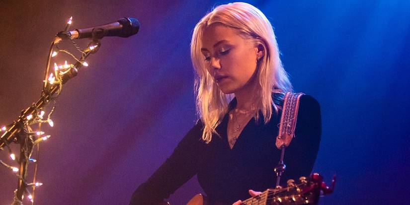 Phoebe Bridgers playing the guitar