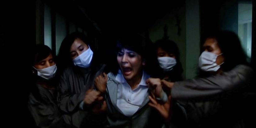 A woman screaming and being attacked in the Safe Haven segment in V/H/S 2