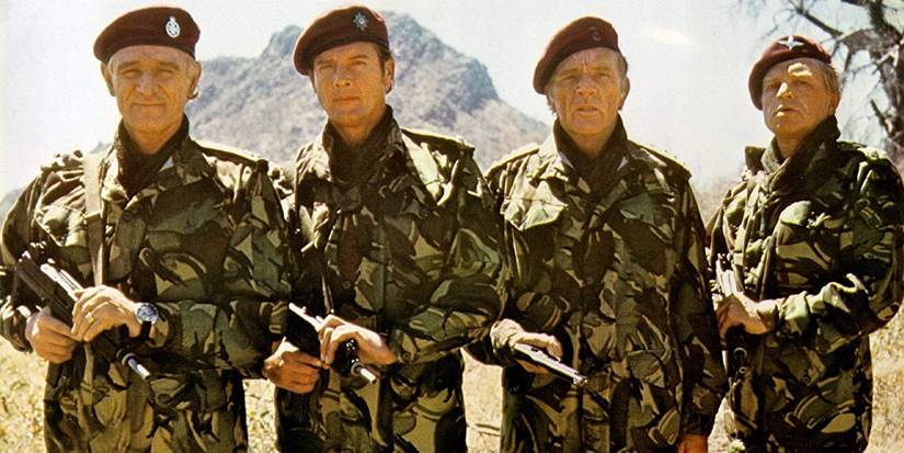 The cast of The Wild Geese posing together with machine guns