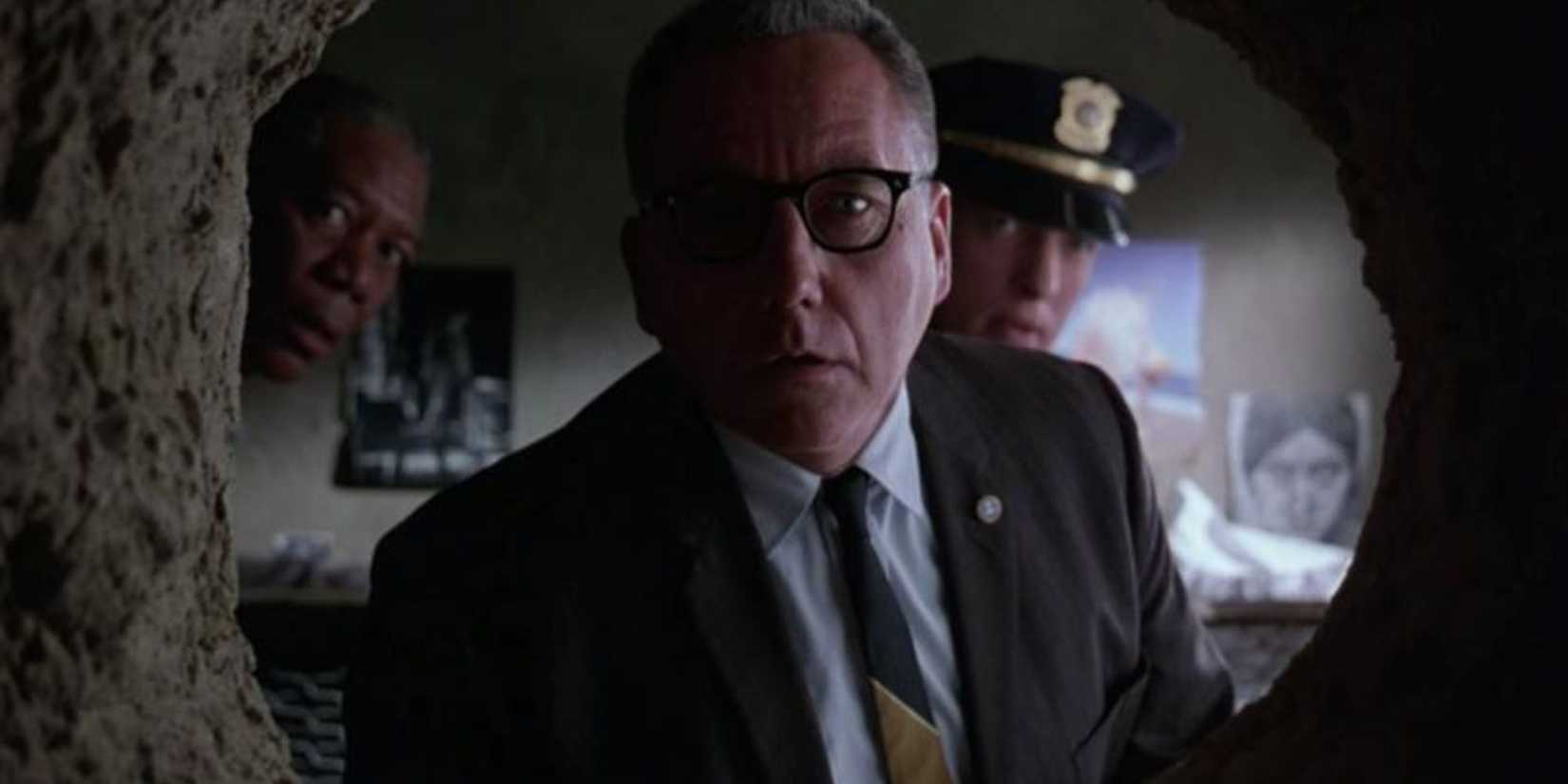 Warden Norton looking through the escape hole in Shawshank Redemption.