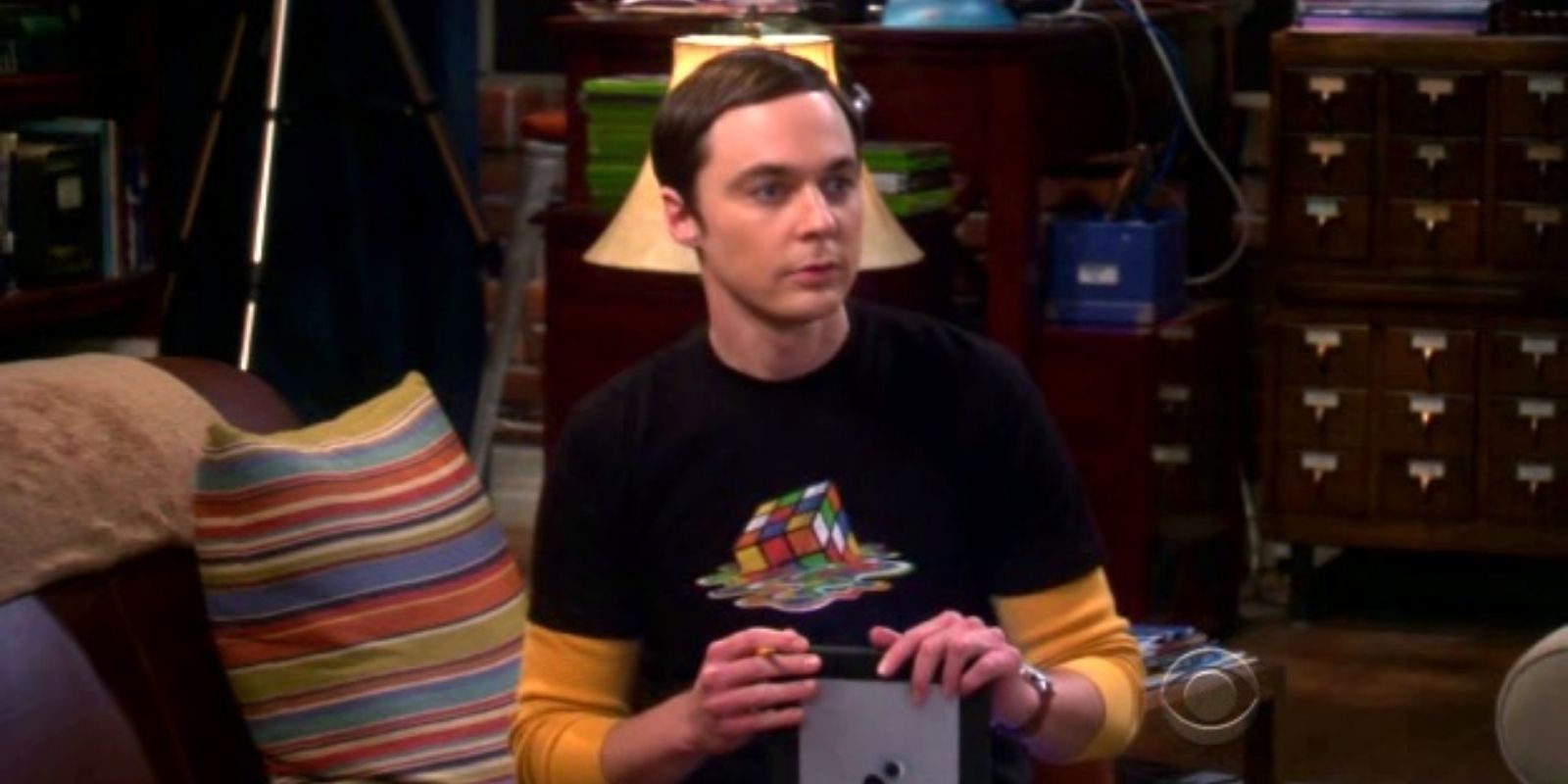 Sheldon Cooper vestindo uma camisa preta com um gráfico de um cubo de Rubik derretido em The Big Bang Theory