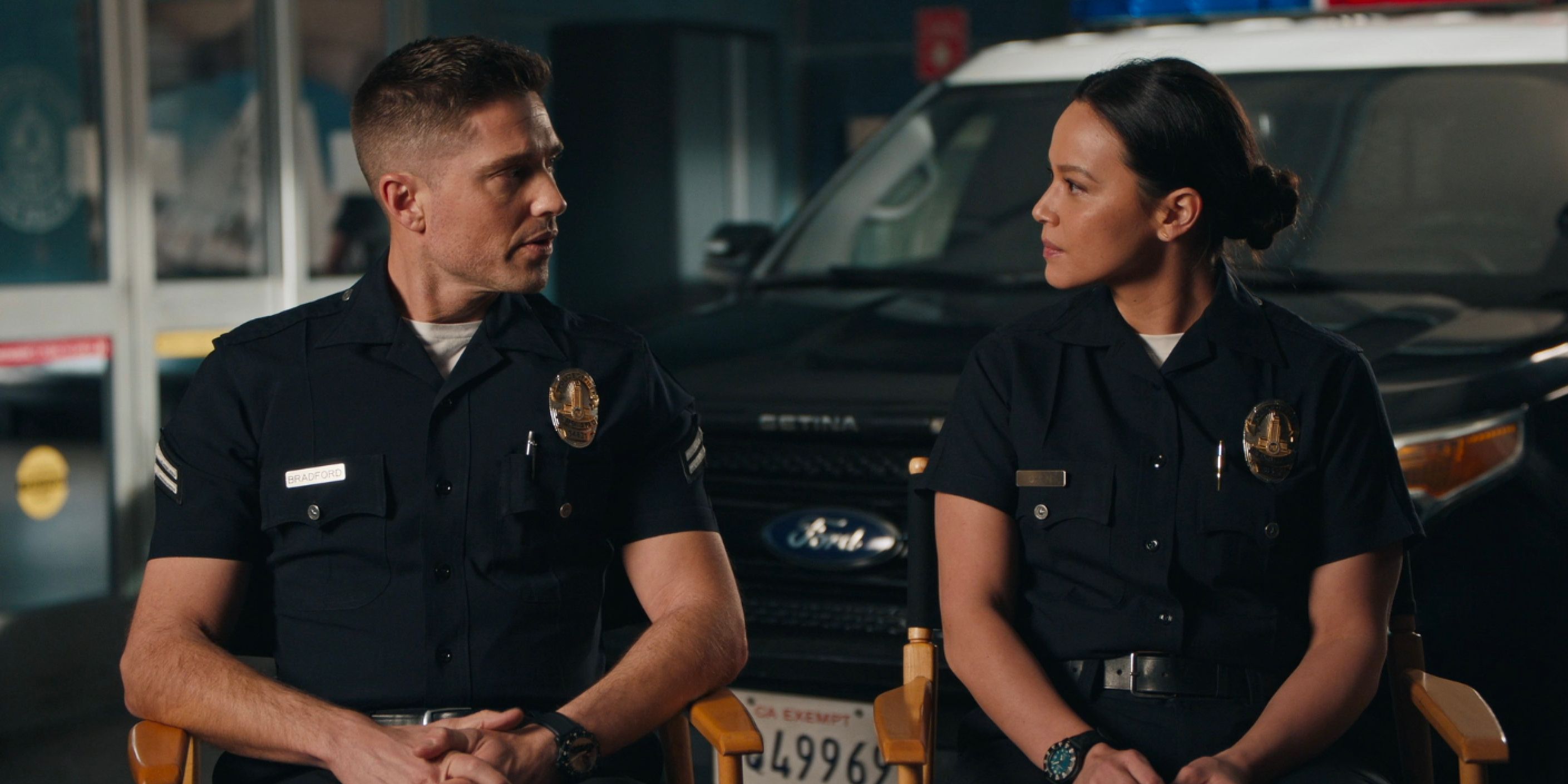 Tim And Lucy In Police Uniforms Standing Next To A Car The Rookie