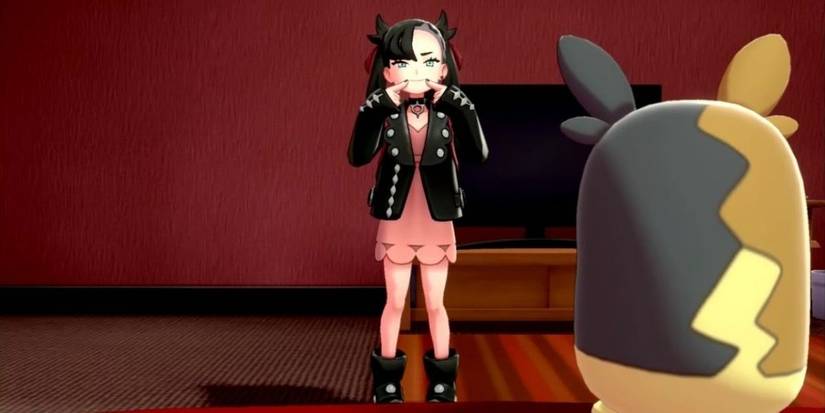 Marnie pushes the corners of her lips up before Morpeko in Sword &amp; Shield's post-game