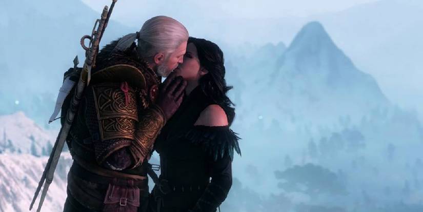 Geralt kisses Yennefer in The Witcher 3: Wild Hunt against a snowy background.