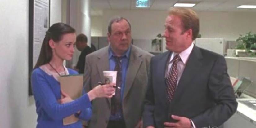 Rory (Alexis Bledel) holding a cup of coffee to his internship on Gilmore Girls