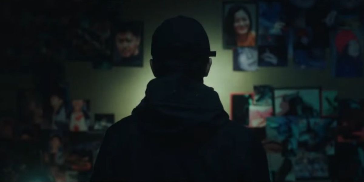 Hidden character looking at wall with photos in Mouse