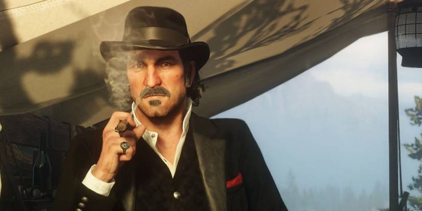 Dutch van der Linde smoking a cigar near his tent in Red Dead Redemption 2's camp.
