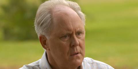 Arthur Mitchell close up standing outside with green grass background in Dexter.