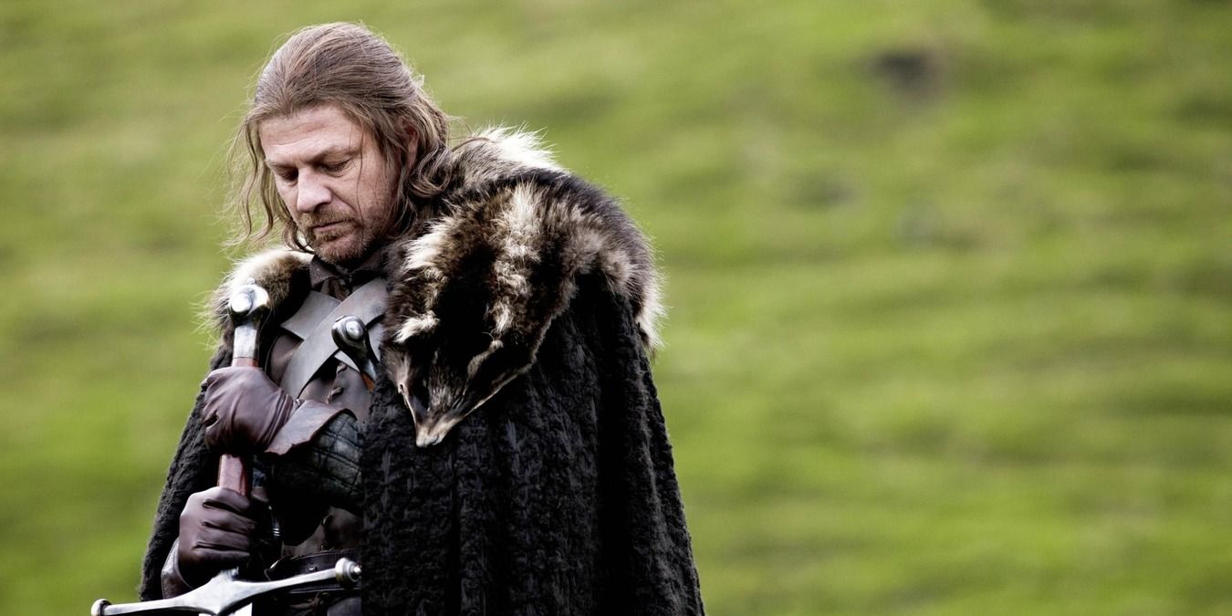 Ned Stark holding his big sword in the green field