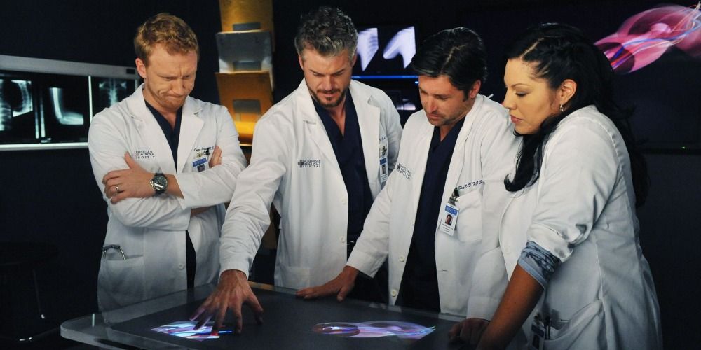 Owen Derek Mark and Callie standing looking at scans in the x ray room in Greys Anatomy
