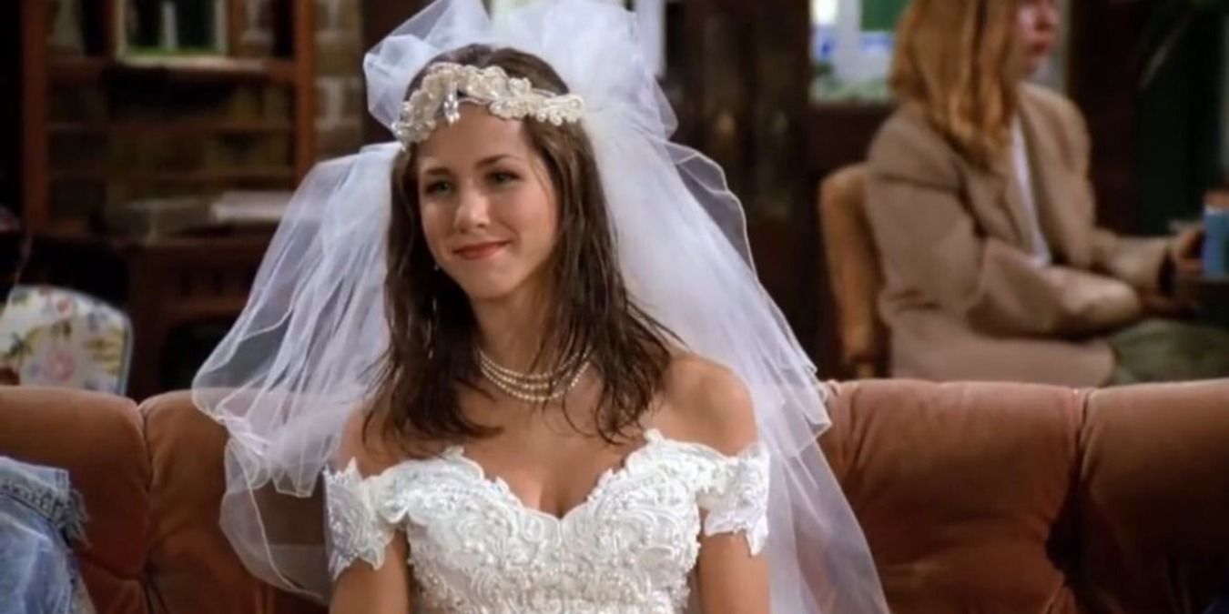 Rachel Green sitting on the couch at Central Perk in her wedding dress during the pilot episode