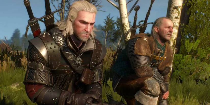 Geralt and Vesemir crouch in the grass in an early cutscene in The Witcher 3